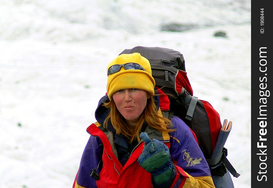 Woman mountaineer makes expressive gesture. Woman mountaineer makes expressive gesture