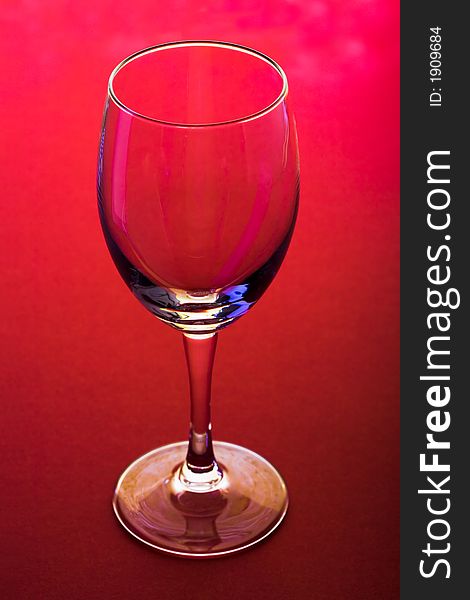 The close up of the wine glass on red