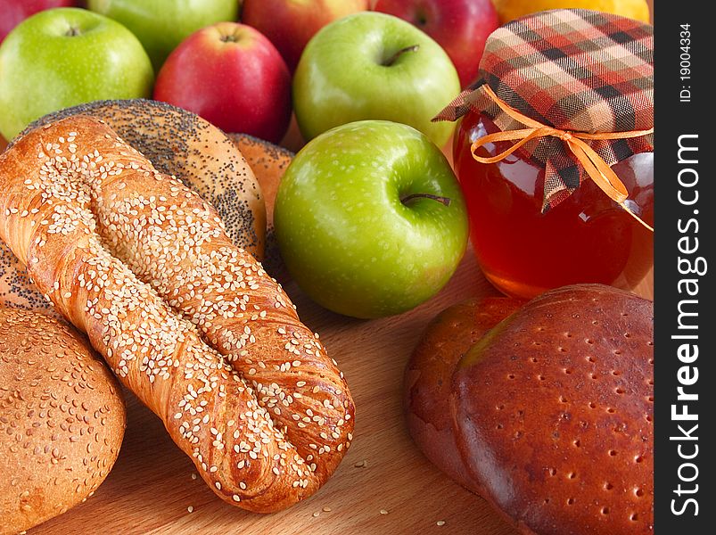 Baking with sesame and poppy seeds, apples and honey on a wooden background . Baking with sesame and poppy seeds, apples and honey on a wooden background .