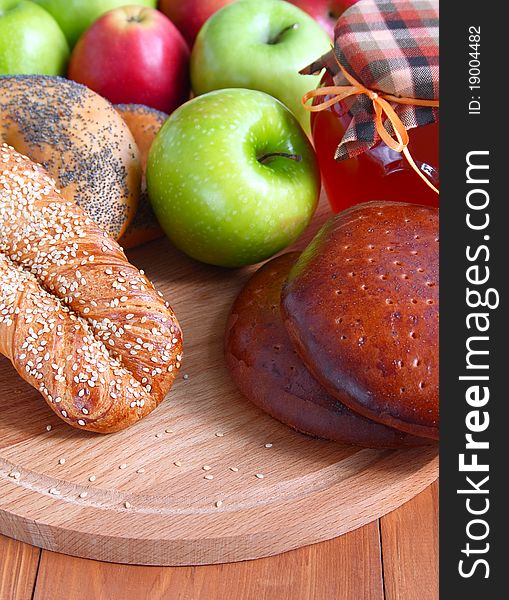 Baking with sesame and poppy seeds, apples and honey on a wooden background . Baking with sesame and poppy seeds, apples and honey on a wooden background .