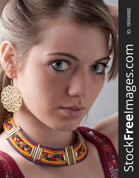 A close up portrait of a beautiful girl wearing exotic jewelry. A close up portrait of a beautiful girl wearing exotic jewelry