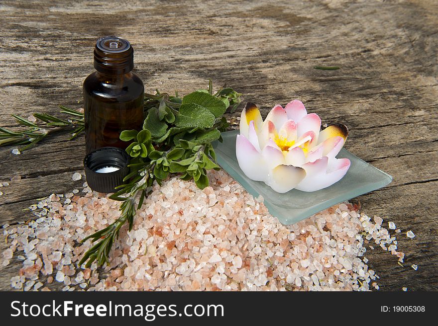 Herbs, aromatic salt and aromatherapy products on wooden background