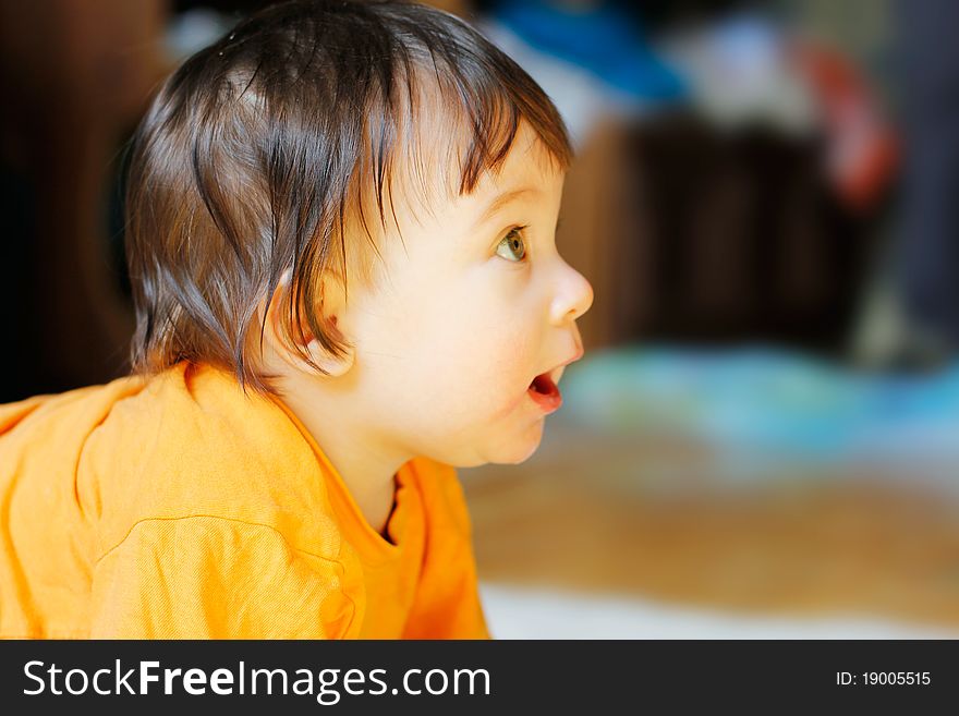 Funny baby looking at something in the room