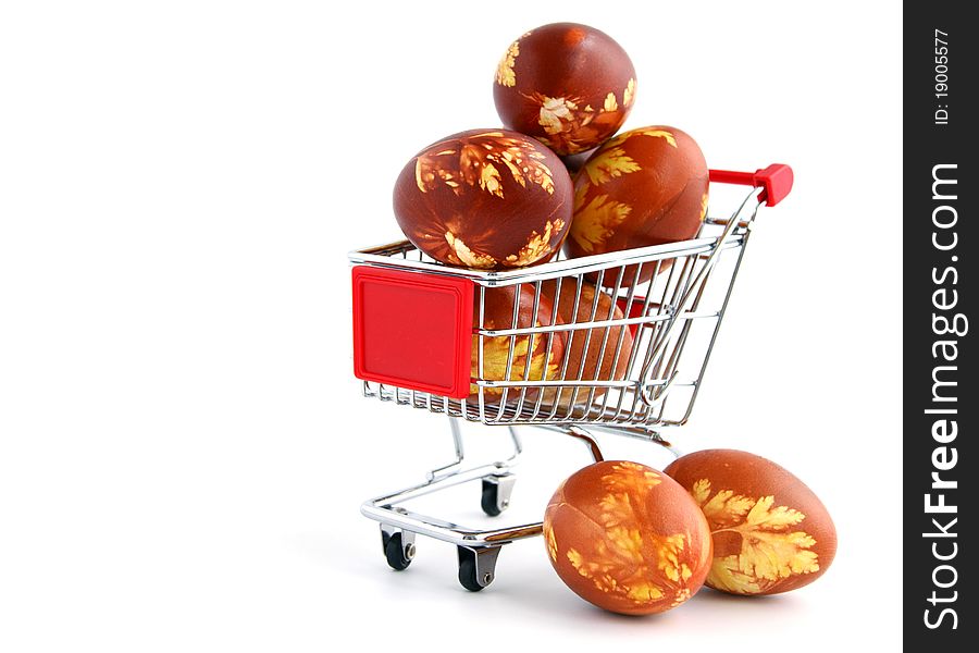 Easter eggs in shopping trolley isolated on white background. Easter eggs in shopping trolley isolated on white background