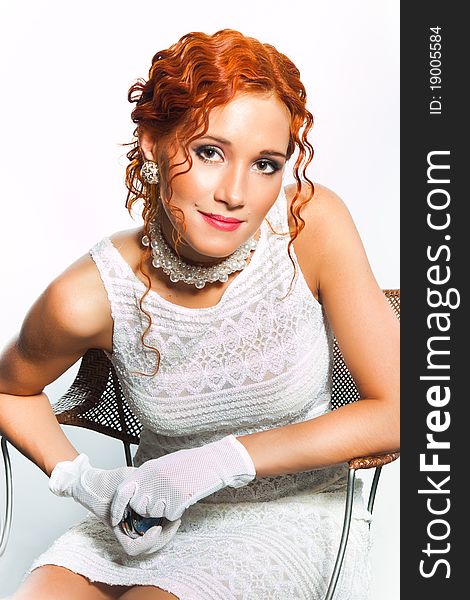 girl with red hair wearing white and pearl