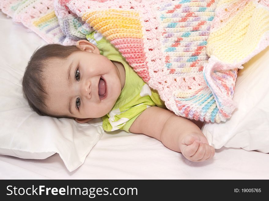 Little girl all wrapped in her colorful blanket. Little girl all wrapped in her colorful blanket