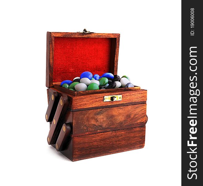 Wooden box with colored stones on a white background. Wooden box with colored stones on a white background