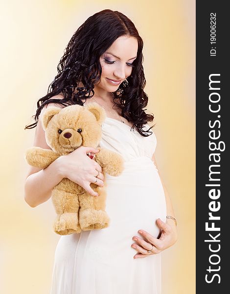 Pregnant woman with teddy bear. Pregnant woman with teddy bear