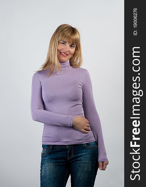 Portrait of beautiful smiling girl standing on staircase and leaning against wall