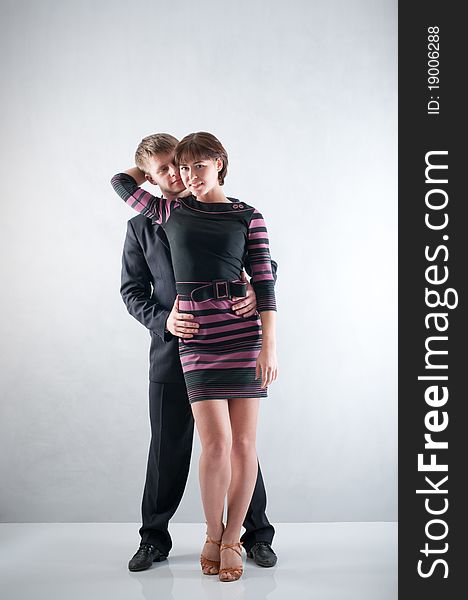 Couple dancing on grey background