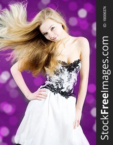 The girl with flying hair on color background