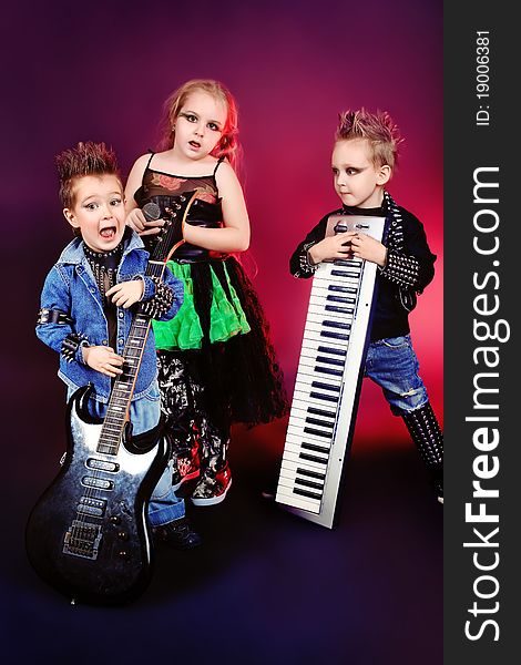 Group of children singing in heavy metal style. Shot in a studio. Group of children singing in heavy metal style. Shot in a studio.