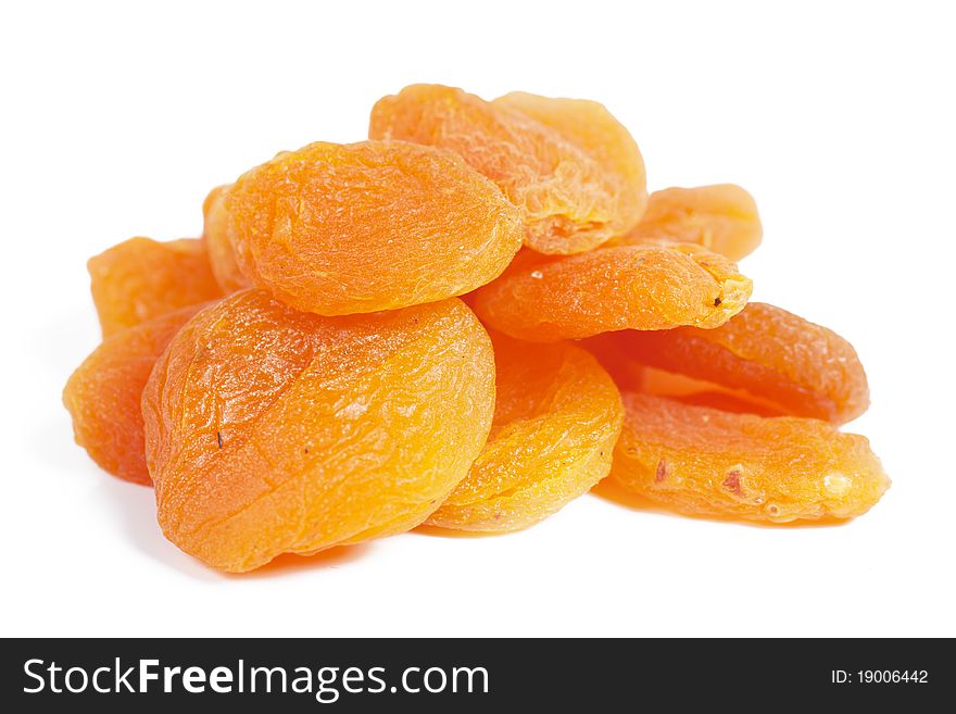A heap of dried apricots over white. Closeup view.