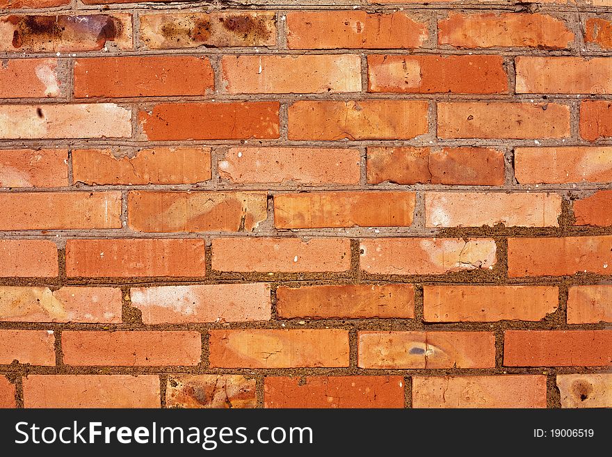 Weathered stained old brick wall background. Weathered stained old brick wall background