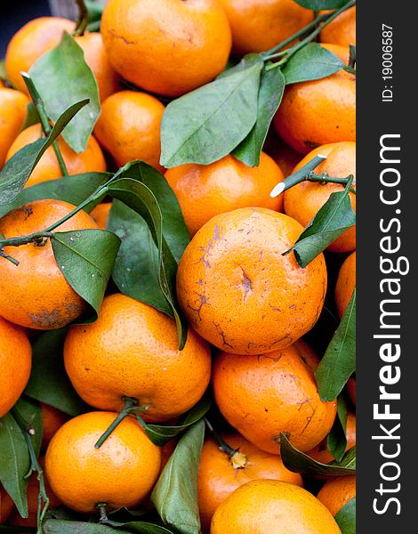 Fresh Picked Tangerines on stems for sale in market in Bali.