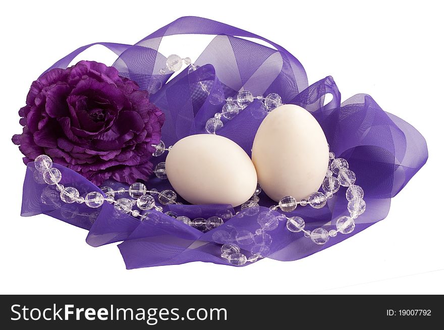 Two eggs and flower in a lovely purple ribbon nest. Two eggs and flower in a lovely purple ribbon nest