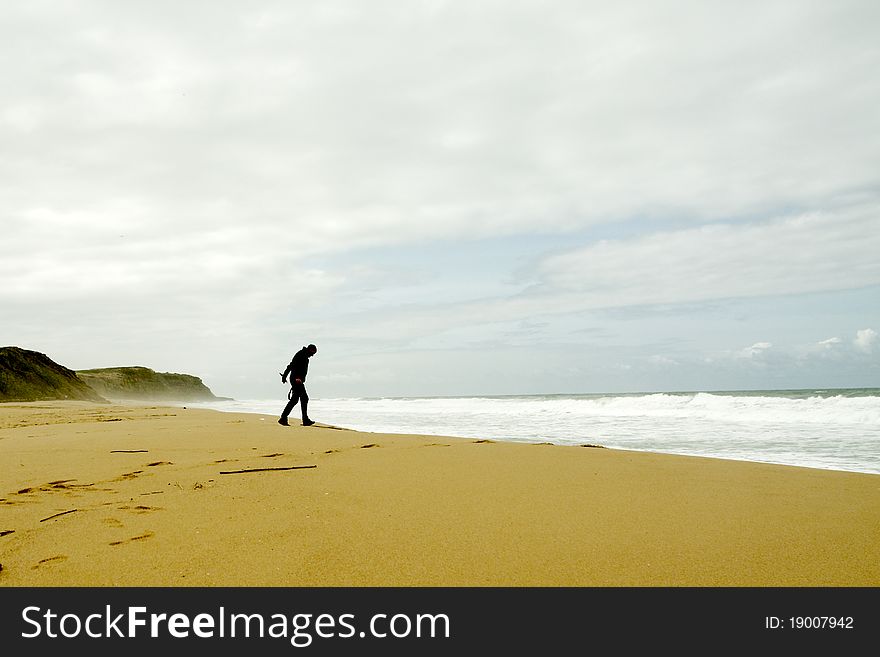 Man walking towards the waves. Man walking towards the waves