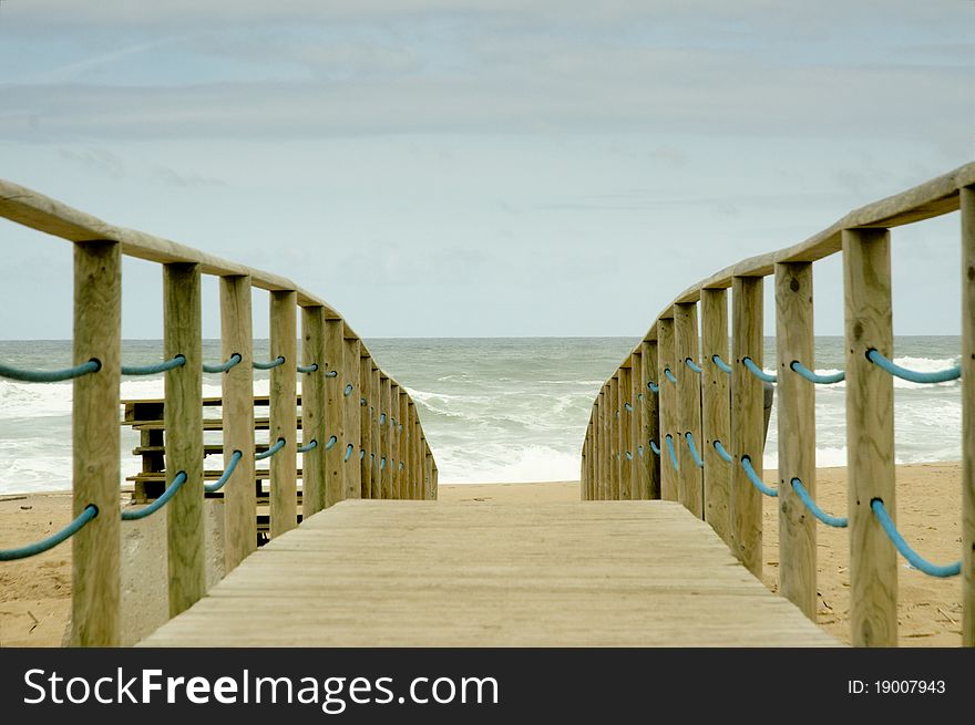 Wood access to empty beach in stormy day. Wood access to empty beach in stormy day