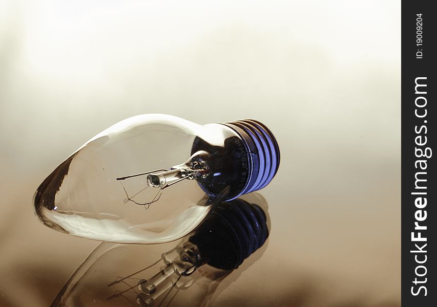 Incandescence bulb on a light brown background. Incandescence bulb on a light brown background