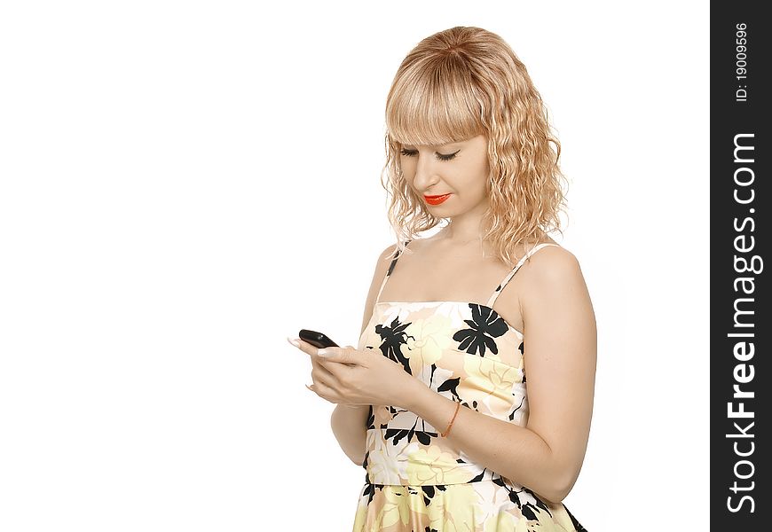 Casual woman sending a text message on her mobile phone - isolated over a white background. Casual woman sending a text message on her mobile phone - isolated over a white background