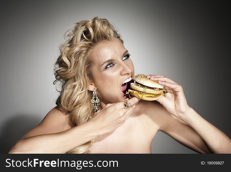 Attaractive beauty woman portrait with burger on grey background. Attaractive beauty woman portrait with burger on grey background