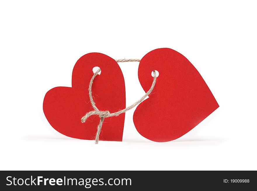 Two red paper hearts constrained with loop of rope on white background. Two red paper hearts constrained with loop of rope on white background