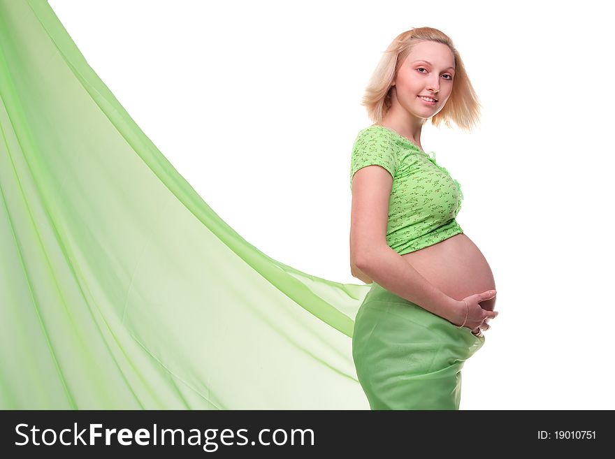 Beautiful young pregnant blonde woman with green transparent cloth in studio. Beautiful young pregnant blonde woman with green transparent cloth in studio