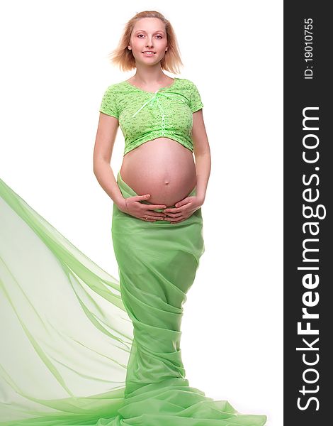 Beautiful young pregnant blonde woman with green transparent cloth in studio. Beautiful young pregnant blonde woman with green transparent cloth in studio
