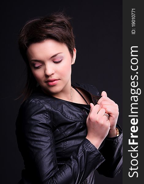 Attractive girl in a black coat posing
