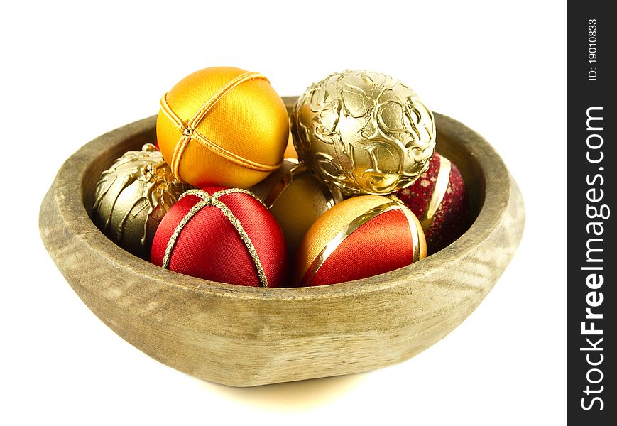 Colorful Easter eggs in a wooden bowl isolated on a white background