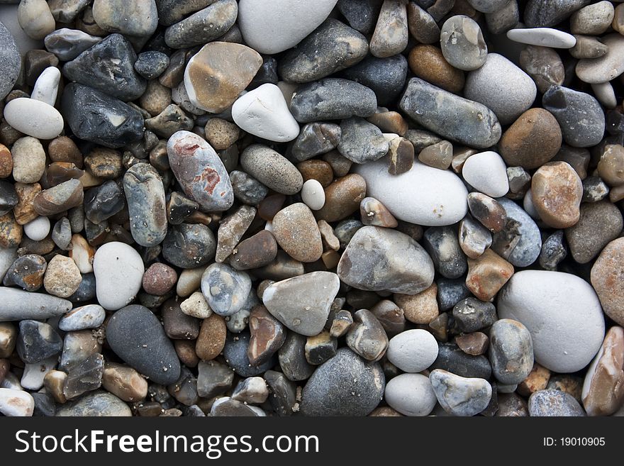 Small pebbles background near sea shore