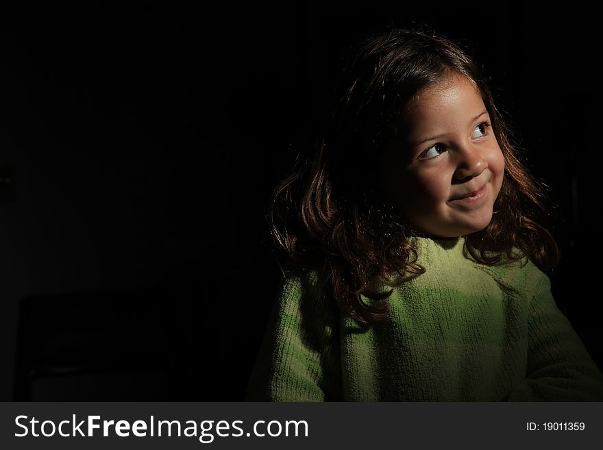 Pretty young girl ingreen jumper looking up to light. Pretty young girl ingreen jumper looking up to light