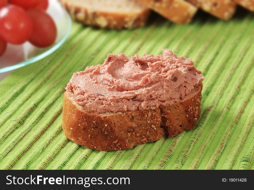 Slice of bread roll and liver pate. Slice of bread roll and liver pate