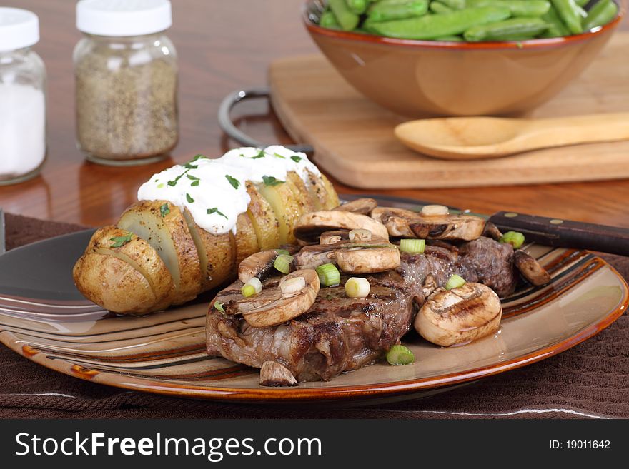 Grilled steak with mushrooms and baked potato. Grilled steak with mushrooms and baked potato