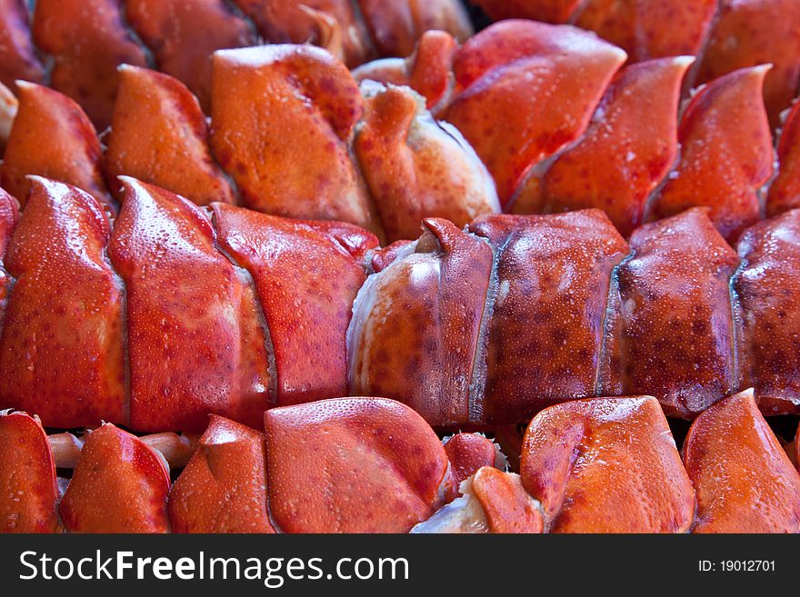 A selection of cooked lobster tails packed like sardines