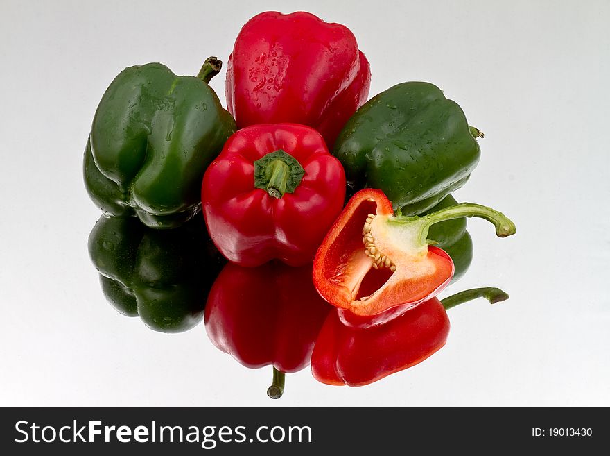 Red And Green Bell Peppers On Reflective Bacground