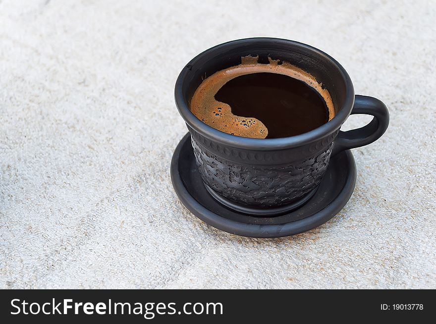 A cup of coffee on a linen tablecloth