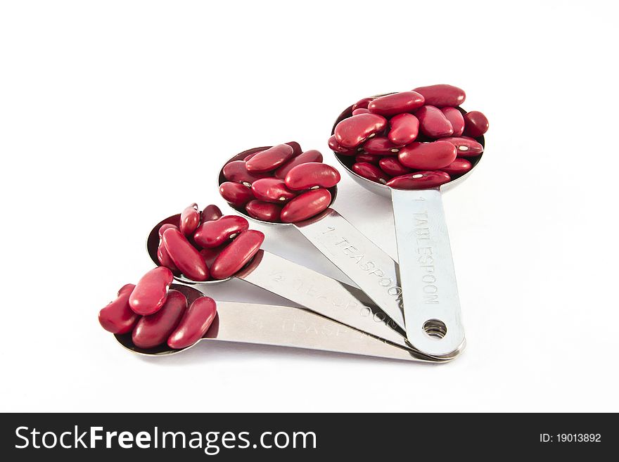 Rad beans measure spoon on white background