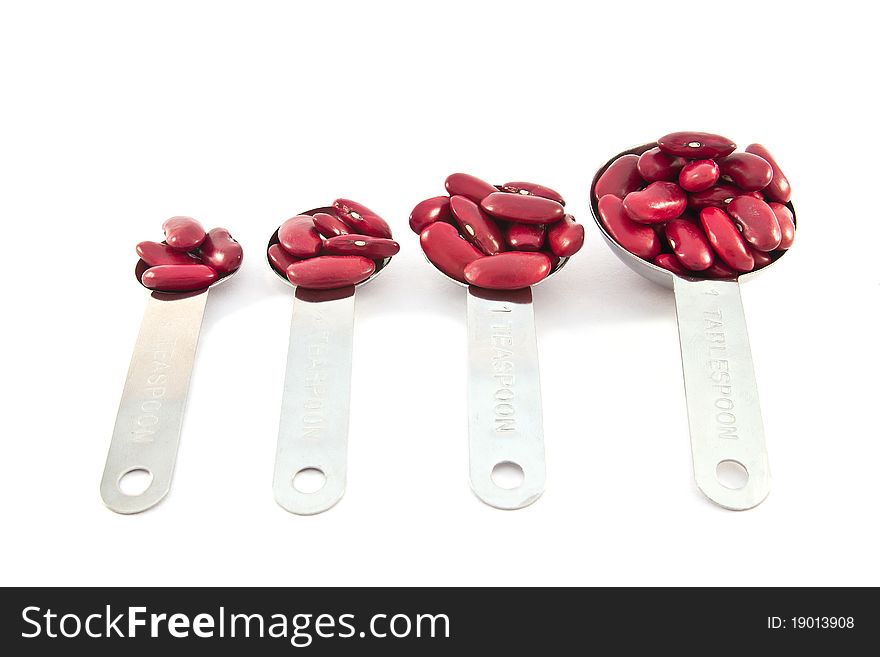 Rad beans measure spoon on white background