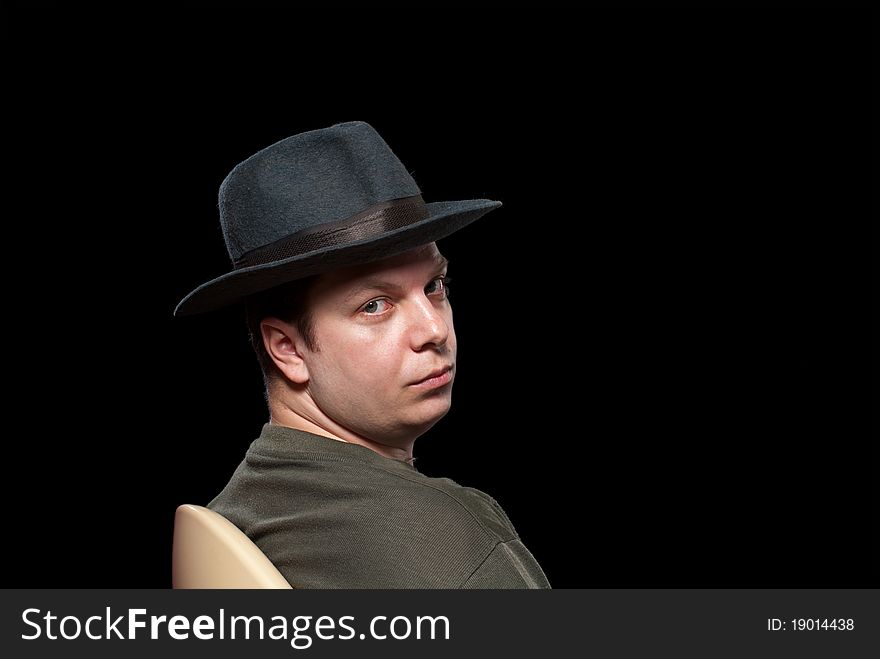 Man in a grey hat. Isolated on black background