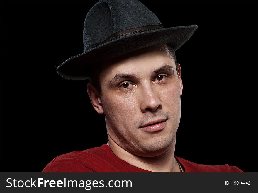 Man in a grey hat. Isolated on black background