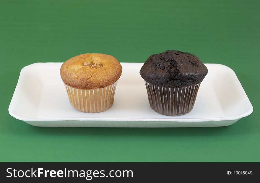 Chocolate and vanilla muffins on white tray