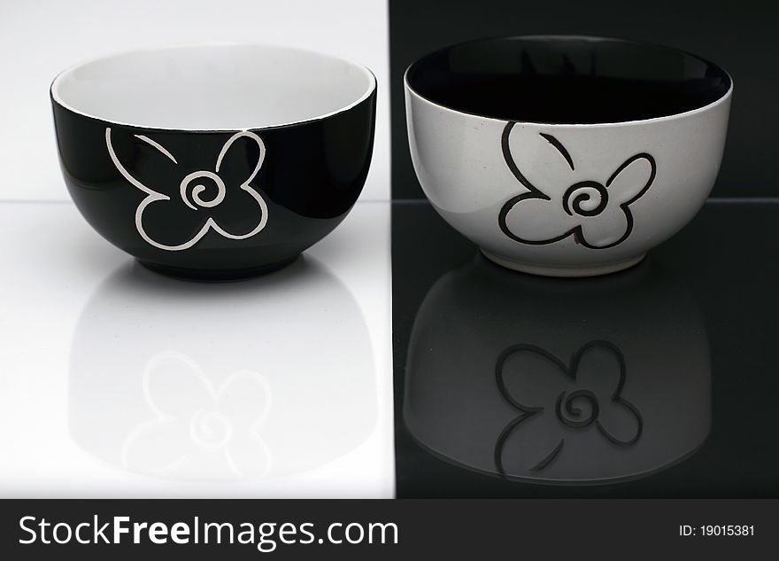 Two black and white porcelain bowls on a black and white background