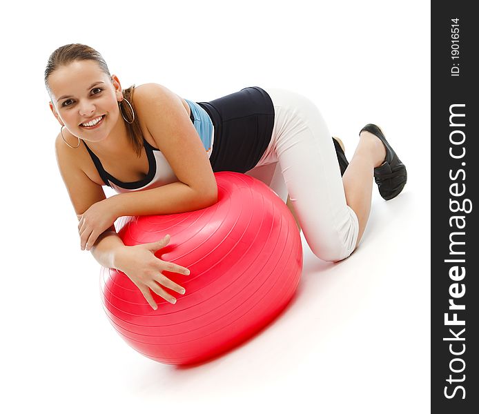 Smiling young woman on a red fitness ball. Smiling young woman on a red fitness ball