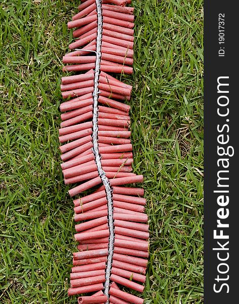 Red Firecrackers on green grass. Red Firecrackers on green grass.