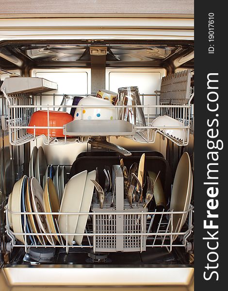 Open dishwasher with clean dishes