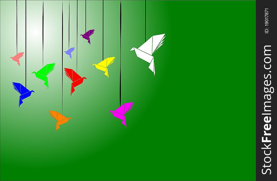 Origami swans on green in variety of colors background. Origami swans on green in variety of colors background