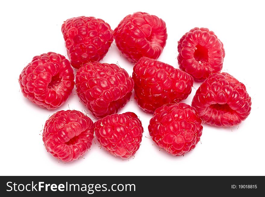 Some fresh raspberries over a white background