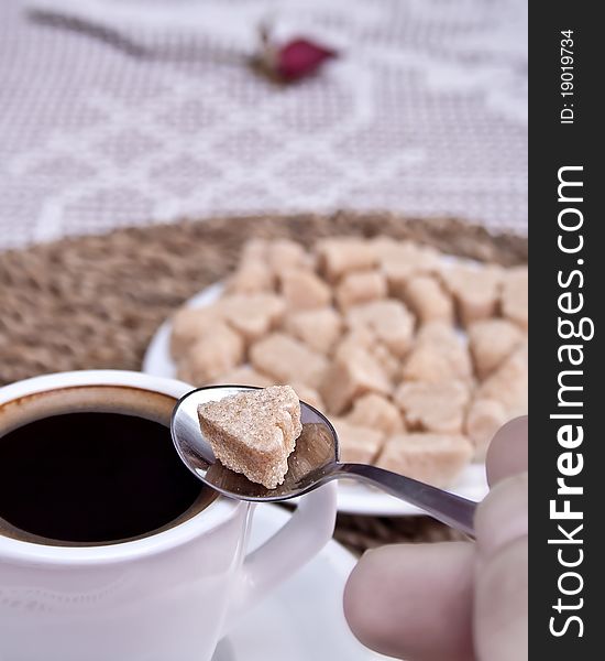 Espresso with a heart-shaped yellow sugar. Espresso with a heart-shaped yellow sugar