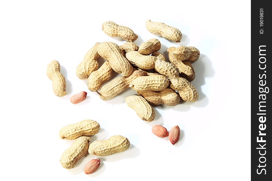 Peanut shells and nut on white background.